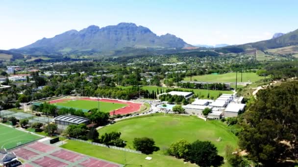 Aerial Drone Rotating University College Sports Athletics Stadium Track Field — Stockvideo