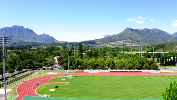 Aerial Drone Rotating Tartan Athletic Track Athletes Training Sprints Mowing — Wideo stockowe