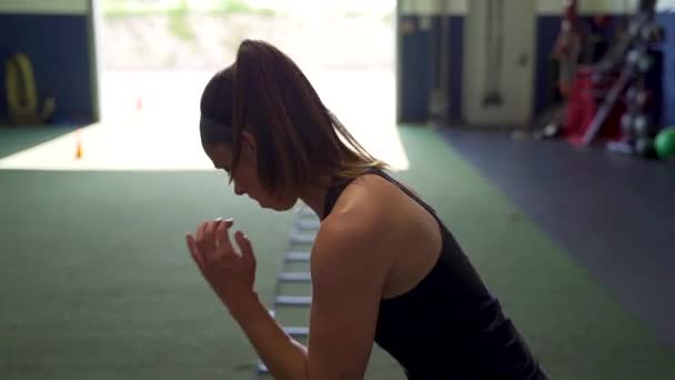 Female Athlete Performing Ladder Sprints Alone Gym — Wideo stockowe