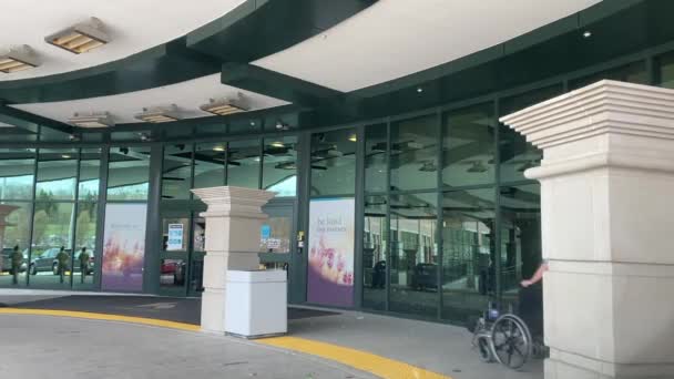 Steady Shot Main Hospital Entrance Showing Nurse Pushing Wheelchair — Stock Video