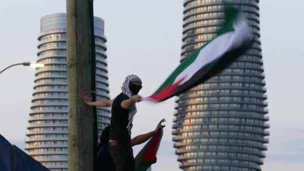 Jonge Man Met Een Masker Wapperende Palestijnse Vlag Tegen Israëlische — Stockvideo