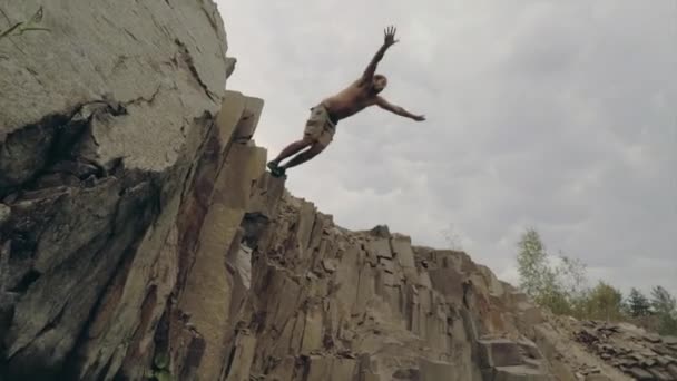 Man Jumps Cliff Lake — Stock Video