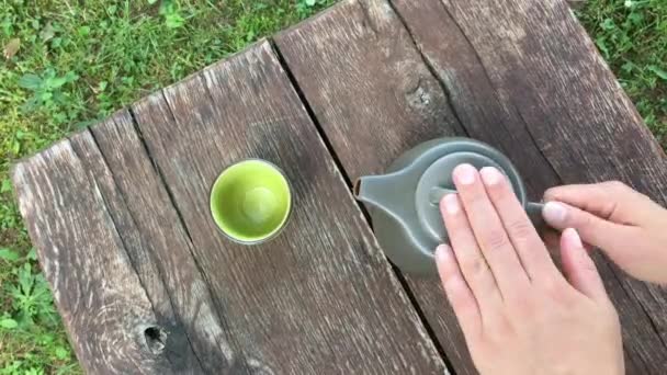 Person Pours Tea Cup — Stock Video