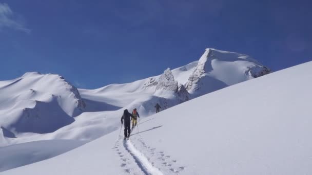 Backcountry Skiers Ascending Mountains Background — Stock video