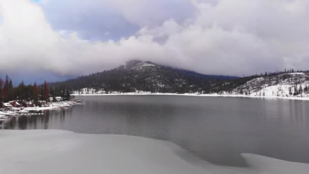 Aerial Pullback Partially Frozen Lake Snow Covered Forested Shores Beautiful — Αρχείο Βίντεο