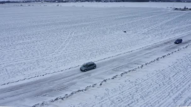 Car Driving Frozen Road Aerial View Other Car Passing — Stock Video