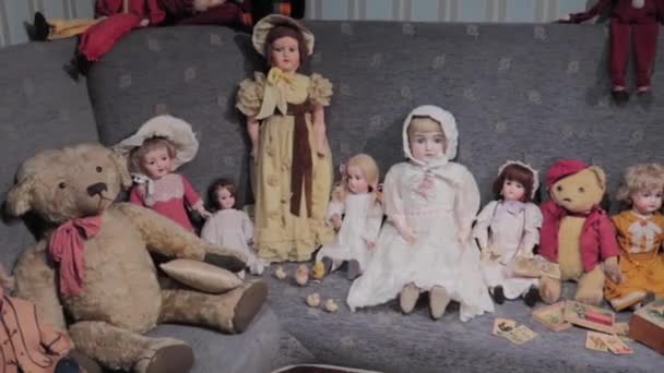 Group Old Dolls Couch Facing Viewer Tracking Right Shot — Vídeo de stock