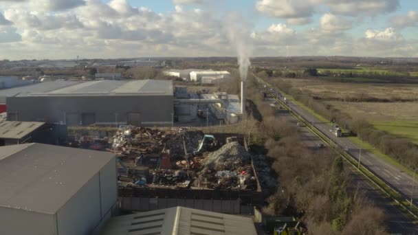 Panning Left Drone Shot Scrap Metal Factory Smoking Chimney — стоковое видео