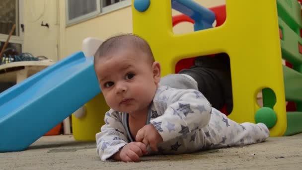 Cute Baby Boy Having Tummy Time While His Older Brother — Stock Video