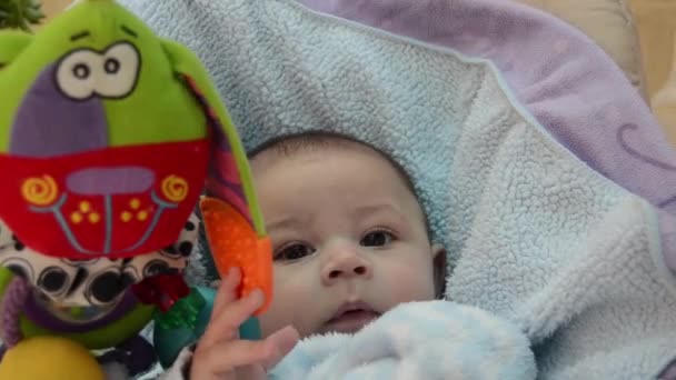 Cute Tree Months Old Baby Boy Trying Eat Blanket While — Stockvideo