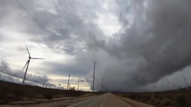 Driving Hyperlapse Windmills Storm Clouds Rural Road Mojave Desert — Stockvideo