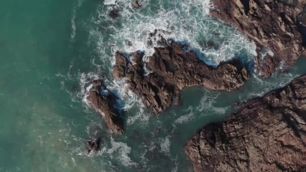 Aerial Stationary Shot Rocks Being Hit Big Waves Plemont Bay — Vídeo de Stock