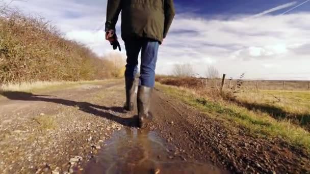 Slow Motion Man Walking Muddy Puddles Showing Full Person Shot — Vídeo de Stock