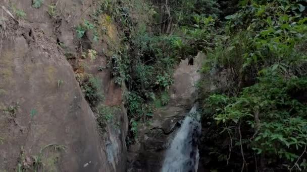 Slow Panning Movement Showing Waterfall Emerging Thick Tropical Mountain Forest — Vídeos de Stock