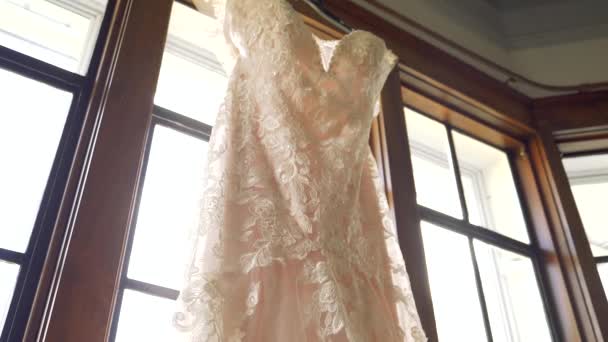 Long Elegant Wedding Dress Hanging Window Frame Tilting Camera Reveals — Stockvideo