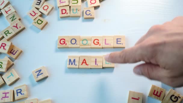 Table Scattered Wooden Letters Person Spelling Google Mail Bluish White — Stockvideo