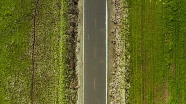 Overhead Shot Road Leading Green Rolling Hills Blue Sky White — Wideo stockowe