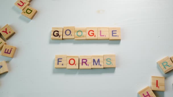 Table Scattered Wooden Letters Person Spelling Google Forms White Background — Stockvideo