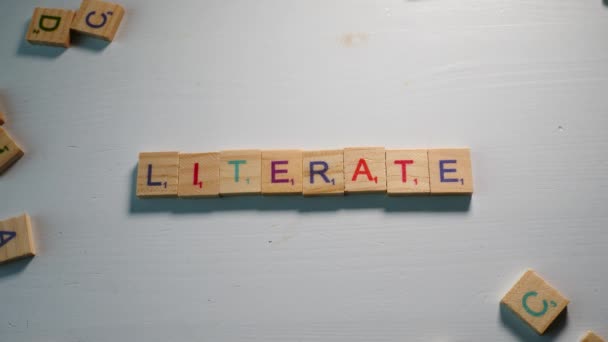 Someone Spelling Literate Wooden Letters White Background Other Scattered Letters — Video