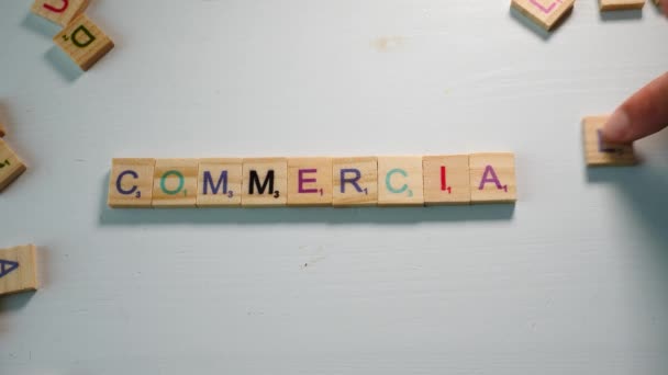 Word Commercial Spelled Wooden Tiles Letters White Background Dramatic Light — 비디오