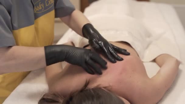 Peaceful Woman Enjoying Back Massage Person Wearing Black Gloves — Stock Video