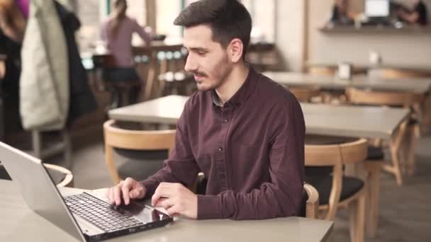 Handsome Man Burgundy Shirt Sits Restaurant Busy Works Using His — Stok video