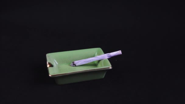 Smoking Ashing Rolled Cigarette Joint Legalised Marijuana Green Ashtray — Vídeo de Stock