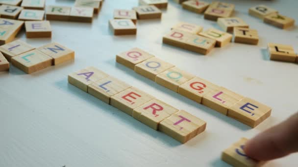 Close Table Scattered Wooden Letters Person Spelling Google Alerts White — Vídeo de stock