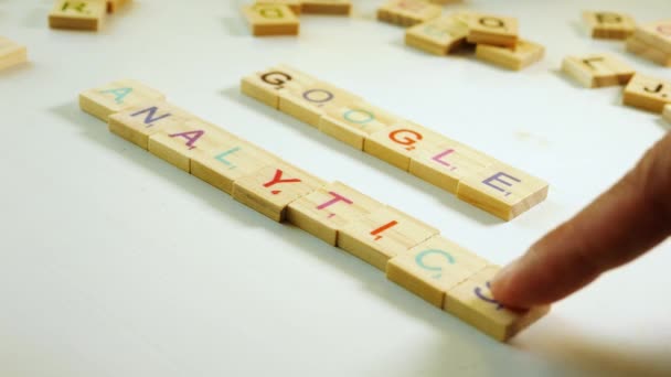 Google Analytics Spelled Wooden Tiles Letters White Background Flat Plane — Stockvideo