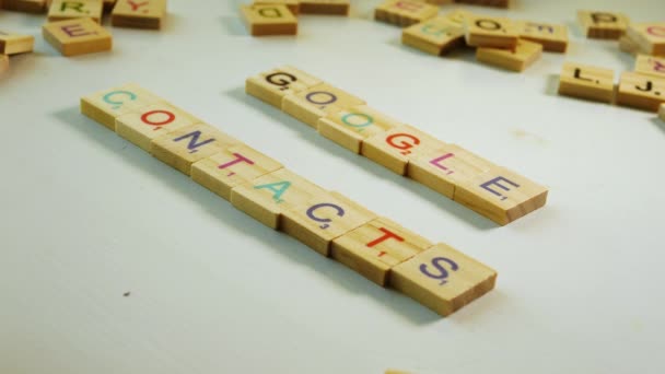 Wooden Letters Composing Google Contacts White Background Other Scattered Letters — Vídeo de Stock
