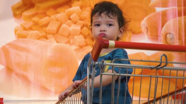 Tired Young Boy Playing Shirt Standing Shopping Cart Waiting Parents — Stock Video