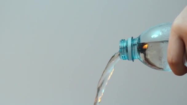 Pouring Out Water Transparent Blue Plastic Bottle Teal Orange Colors — Stock videók