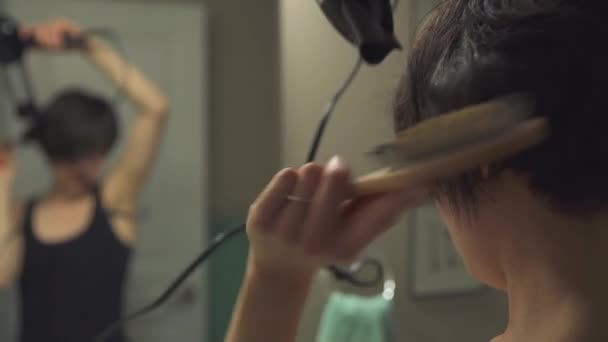 Woman Blowdrying Brushing Her Hair While Looking Mirror — Stock Video