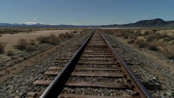 Fast Low Aerial View Moving Forward Straight Railroad Tracks Desert — Stock Video