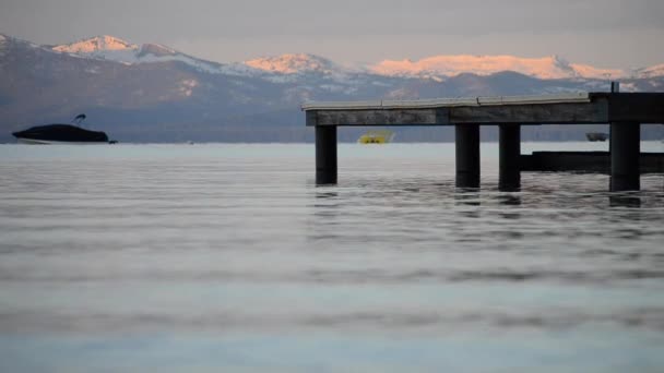 Ruhige Wellen Krachen Gegen Pier Lake Tahoe Mit Schneebedeckten Bergen — Stockvideo