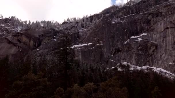 Slow Rotating Shot Looking Sheer Granite Cliff Faces Mist Trail — Stock Video