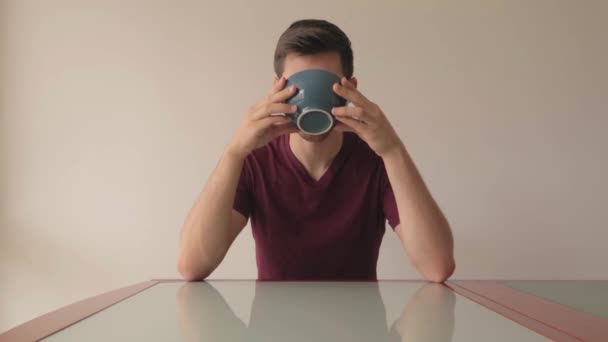 Young Man Sitting Glass Table Drinking Cereals Minimalistic Setup Indoors — Stock Video