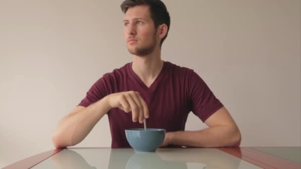 Man Zit Aan Tafel Eet Zijn Granen Draait Met Lepel — Stockvideo