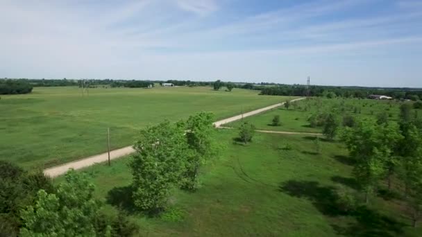 Aerial Pass Rural Landscape Grasslands Trees Dirt Road Water Tank — Stock Video