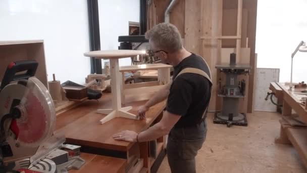 Woodworker Examines Hand Made Table Wood Shop — Stock Video