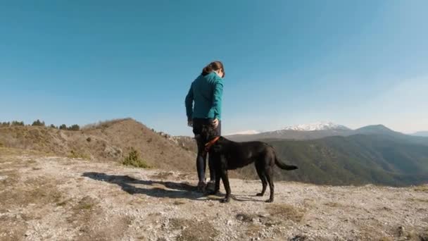 Girl Cuddling Black Labrador Dog Mountain Sunny Autunm Day — Stock Video