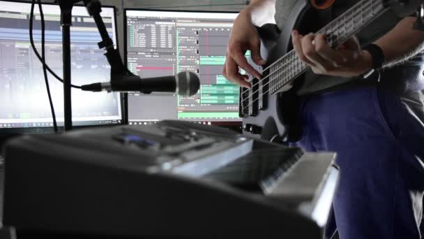 Musician Playing Bass Guitar Home Studio Screens Displaying Software — Stock Video