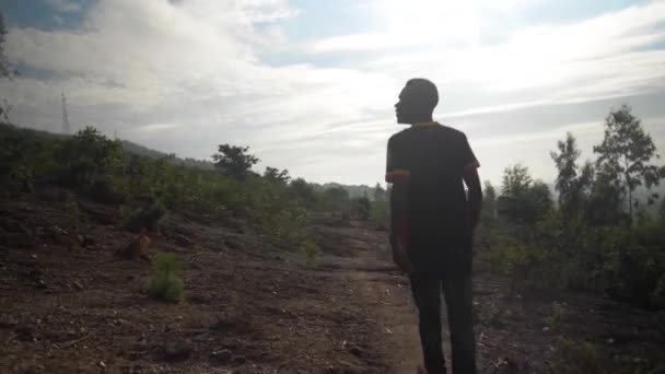 Sebuah Tembakan Pelacakan Dari Siluet Seorang Pria Afrika Saat Berjalan — Stok Video