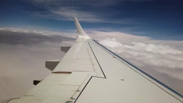 Skrzydło Samolotu Wlatujące Grubą Warstwę Chmur Pod Błękitnym Niebem Słońcem — Wideo stockowe