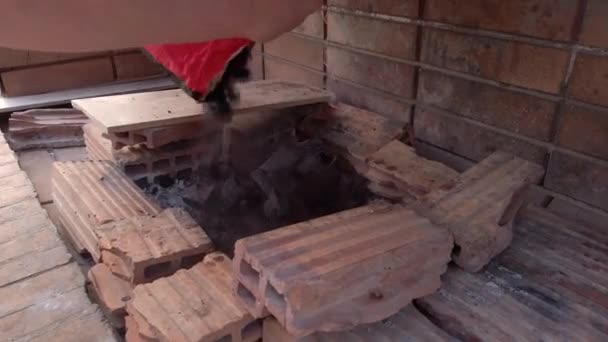Wide Shot Man Pouring Charcoal Greek Style Stone Bbq Pit — Stock Video