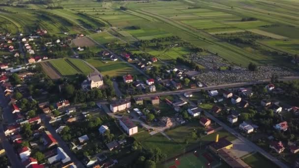 夕暮れ時にポーランドの田舎の小さな町の傾斜と空中の景色 — ストック動画