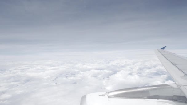 美しい青空と白い雲とキャビンの窓の外に旅行しながら 飛行飛行機の翼とエンジンの眺め — ストック動画
