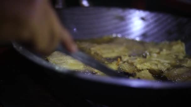 インドネシア料理を作る屋台のショットは 油を調理するボウルにそれを揚げて販売する — ストック動画