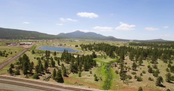 Aerial Passing Pair Parallel Railroad Tracks Isolated Pond Williams Arizona — Stock Video