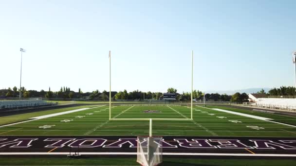 Drone Shot Empty High School Football Field Track Going Bleachers — Stock Video